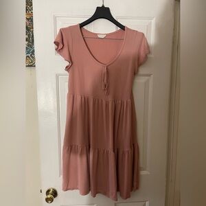 See You Monday ribbed knit babydoll dress. It's a mauve pink, short-sleeved.